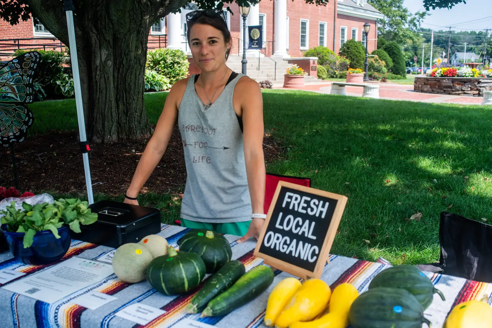 A vendor with fresh local organic produce, with Enfield Town Hall in the background